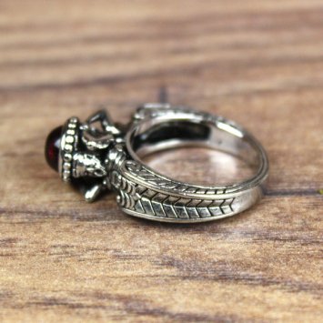 Ring with man and woman in antique style and red hemisphere stone